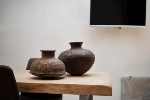 two vases sitting on top of a wooden table at Agriturismo Castello Santa Margherita in Cori