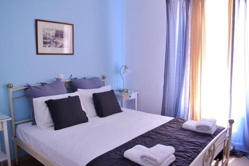 a blue bedroom with a bed with two towels on it at Mer Bleu Luxury Apartments in Ambelas