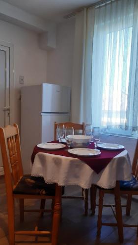 a dining room table with two chairs and wine glasses at Hris in Chernomorets
