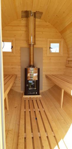 a room with a stove in a log cabin at Shepherd's Loch Glamping in Turriff
