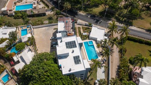 an aerial view of a white house with a swimming pool at Skylight Suites Hotel in San Felipe de Puerto Plata