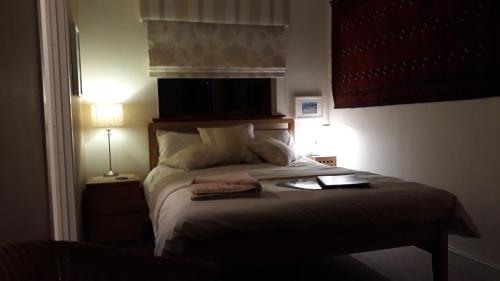 a bedroom with a bed with two towels on it at Garragh Mhor in Oban