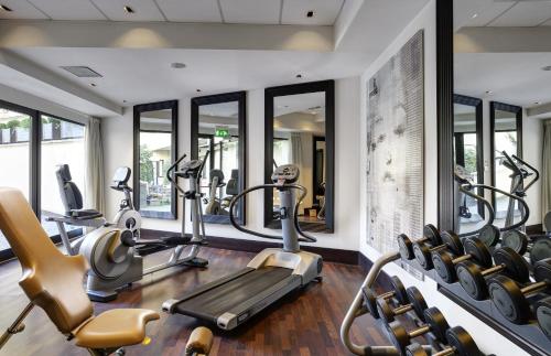 a gym with treadmills and elliptical machines at Hotel Pulitzer in Rome