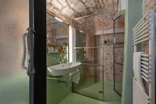 a bathroom with a sink and a shower at Il Quinto Elemento - Residence Of Charme in Ostuni