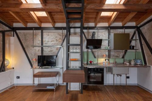 a kitchen in a loft with wooden ceilings at Il Quinto Elemento - Residence Of Charme in Ostuni