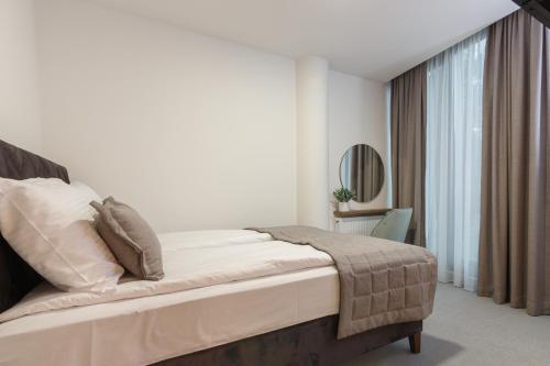 a bedroom with a bed and a large window at Korzo Apartments Visoko in Visoko