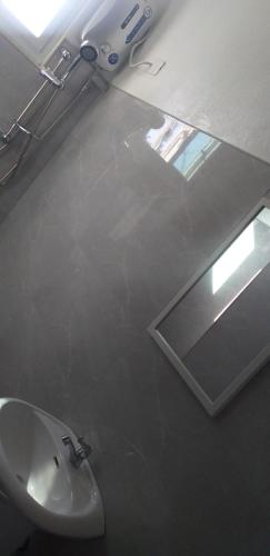 a bathroom with a sink and a mirror at Strandhaus Condotel in Moalboal