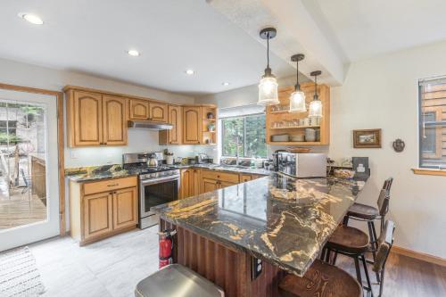 a kitchen with wooden cabinets and a marble counter top at 1486 Oak- Grandview in Ouray