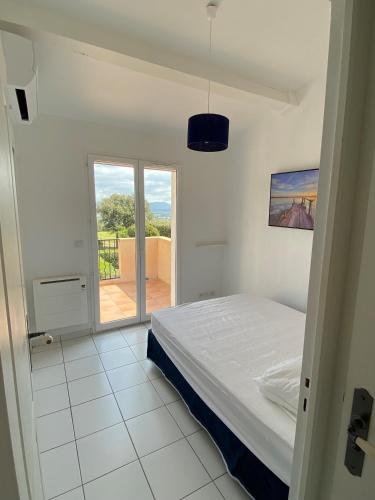une chambre avec un lit et un balcon dans l'établissement Au Domaine Du Golf YourHostHelper, à Roquebrune-sur Argens