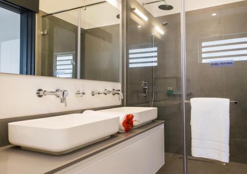 a bathroom with a large white sink and a shower at O'Biches by Horizon Holidays - Trou aux Biches in Trou aux Biches