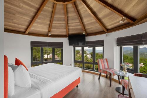 a bedroom with a bed and a table and chairs at De La Sol Villa Dalat in Da Lat