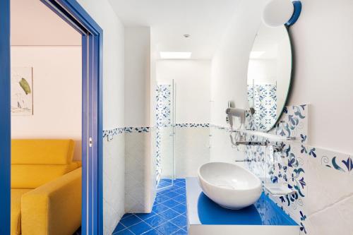 a bathroom with a sink and a mirror at Don Leonardo - pool and wellness in Polignano a Mare