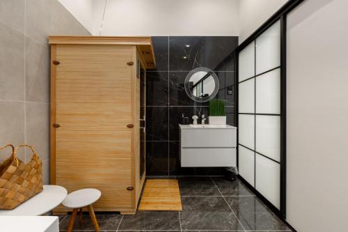a bathroom with a sink and a mirror at SUPER CENTRAL 2BR-2BT with Balcony&View&Sauna&Jacuzzi in Budapest