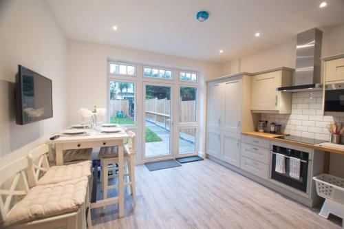 a kitchen with a island in the middle of a room at New stylish 4 bed house moments from Clacton beach in Clacton-on-Sea