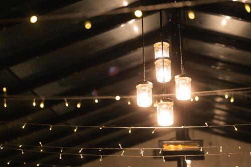 a bunch of lights hanging from a ceiling at Fox And Hounds Llancarfan in Barry