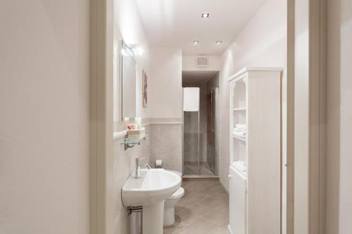 a white bathroom with a sink and a toilet at B&B CORTE SAN MICHELE Desenzano in San Martino della Battaglia