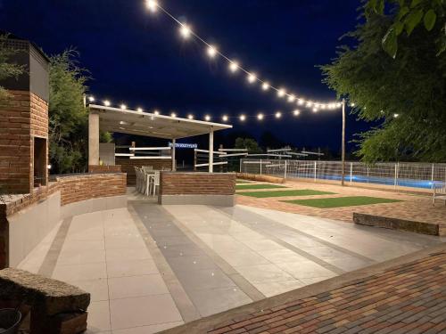 a lit up patio with lights and a pavilion at night at Casa Rural VILLA KAIROS in Ajofrín