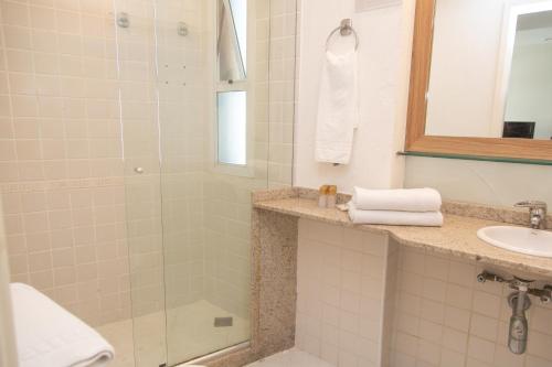 a bathroom with a shower and a sink at Lobie Queen Ipanema in Rio de Janeiro