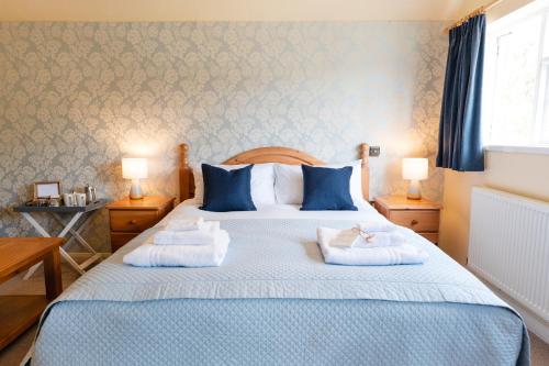 a bedroom with a bed with two pillows on it at Fox And Hounds Llancarfan in Barry