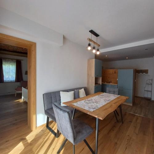 a kitchen and dining room with a wooden table and chairs at Auerhiasbauer in St. Wolfgang