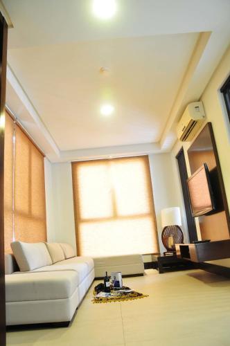 a living room with a white couch and a window at Kamana Sanctuary Resort & Spa in Olongapo