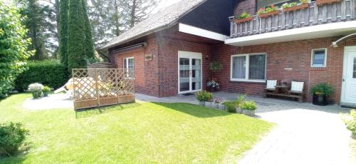 a brick house with a garden in front of it at Ferienwohnung Kröger in Rhede