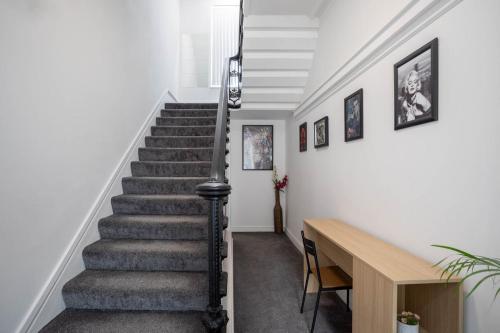 a staircase in a home with a stair case at Dusties Hotel in Rotherham