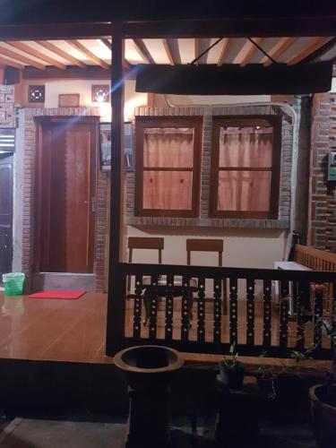 a room with two doors and a table and chairs at Homestay Durohman Borobudur in Mendut