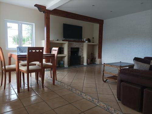 a living room with a table and chairs and a couch at Casa Cabárceno in Santiago