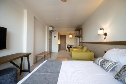 a hotel room with a bed and a living room at VIGLA IERISSOS in Ierissos