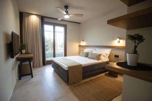 a bedroom with a bed and a large window at VIGLA IERISSOS in Ierissos