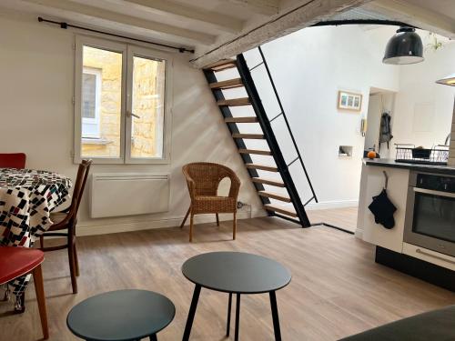 - un salon avec un escalier, une table et des chaises dans l'établissement Charmant studio au cœur de l’écusson, à Montpellier