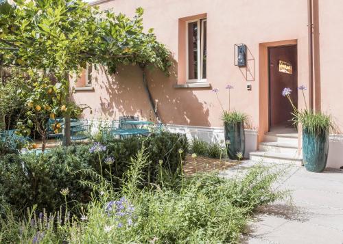 a garden in front of a house with purple flowers at Antica Dimora Le Misure in Cervia
