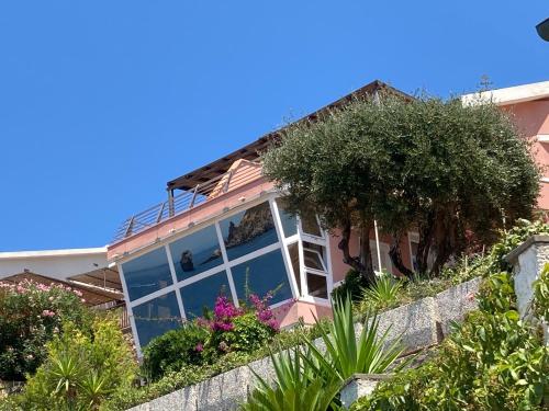 a house with a large window and some plants at Vetrata sul mare in Campese