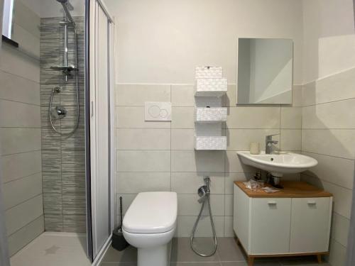 a bathroom with a toilet and a sink and a shower at Amoenus Bed & Breakfast in family in Soverato Marina