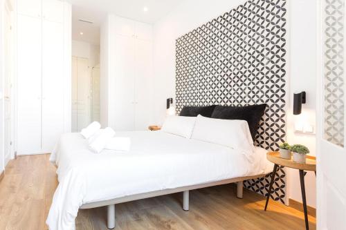 Gulta vai gultas numurā naktsmītnē Cozy Apartment close to Passeig de Gracia