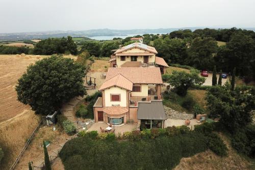 a large house on top of a field at AgriResort Spa Glamping Poggio Di Montedoro in Montefiascone