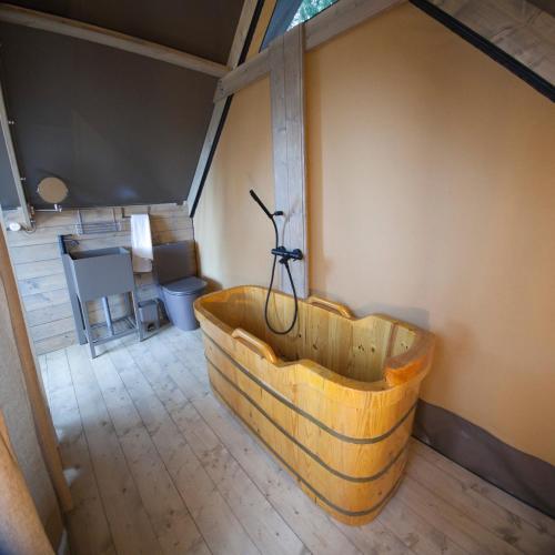 a wooden tub in the middle of a room at AgriResort Spa Glamping Poggio Di Montedoro in Montefiascone