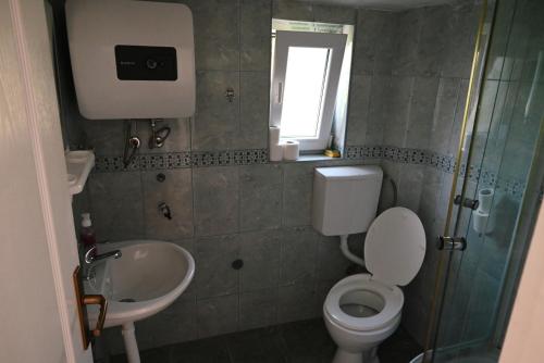 a small bathroom with a toilet and a sink at Top Jaz Apartments in Budva