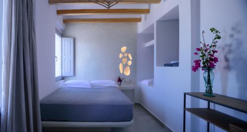 a white bedroom with a bed and a bath tub at Acro Blue Luxury Villas in Akrotiri