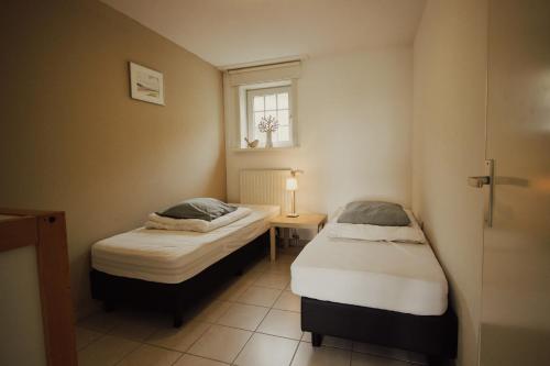 Tempat tidur dalam kamar di de Paardenstal
