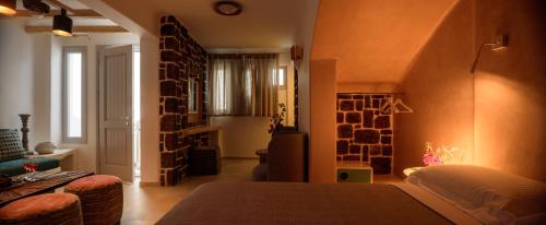 a bedroom with a bed and a living room at Acro Blue Luxury Villas in Akrotiri