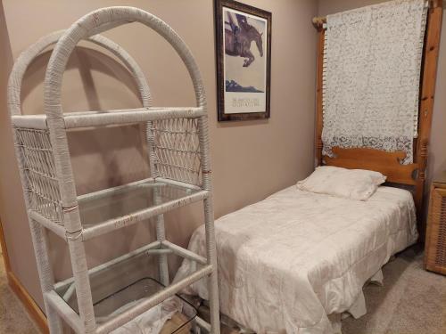 a room with a white ladder next to a bed at Cowgirl Palace in Sag Harbor