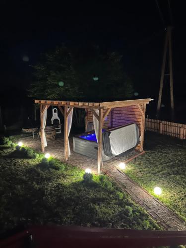 a gazebo at night with lights on the grass at Rubin in Doba