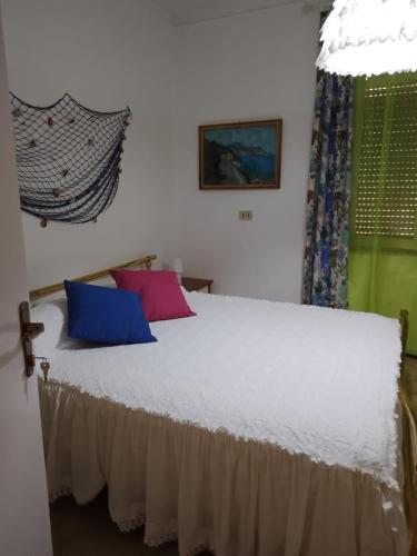 a bedroom with a bed with two pillows on it at Palazzo tre palme in Follonica
