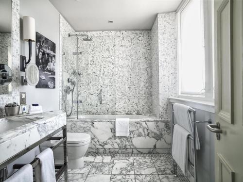 a bathroom with a sink, toilet and bathtub at The Balmoral Hotel in Edinburgh