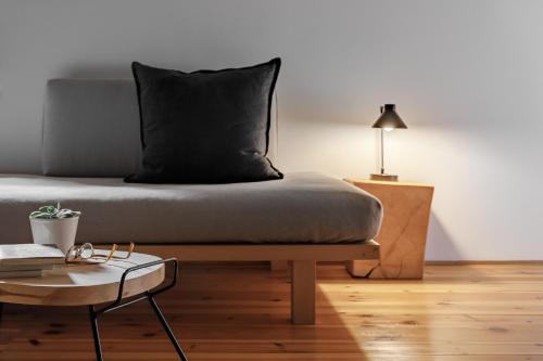 a bed with a black pillow on top of a table at Cal Calsot Casa Rural "Adults Only" in Montellá