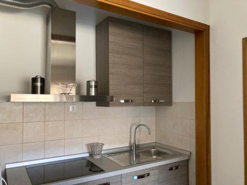 a kitchen with a sink and a mirror at Casa Selia in Cecina