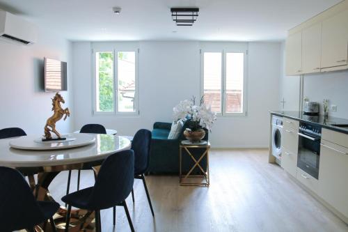 a kitchen and living room with a table and chairs at Hotel Sonne Interlaken-Matten in Interlaken