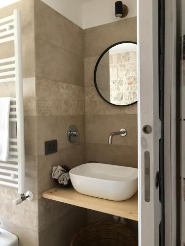 a bathroom with a sink and a mirror at Aria di Casa Country Resort in Alberobello